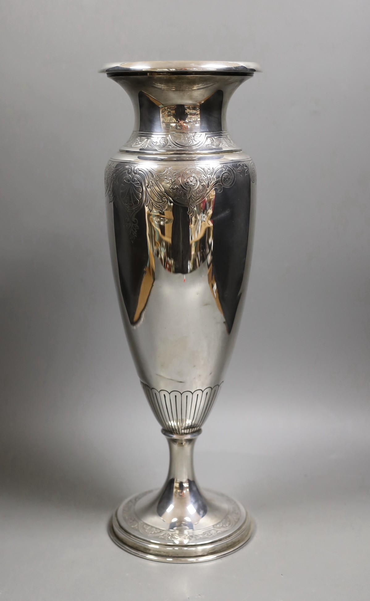 A North American sterling tall vase, with engraved decoration, 40.6cm, weighted.
